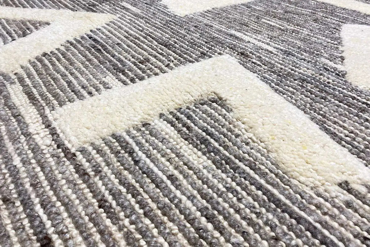 Berber rug detail: gray woven lines, light areas, short pile