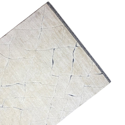 Flat rug in light cream with fine blue lines and a decorative border