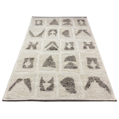 Berber rug with a beige base, rectangular, black-gray tribal pattern in panels