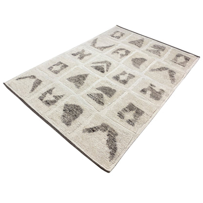 Berber rug with beige pile and square gray motifs, rotated diagonally