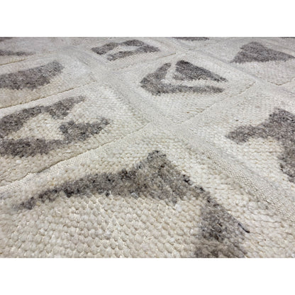 Close-up: Berber rug with beige pile and gray patterns in a block grid pattern