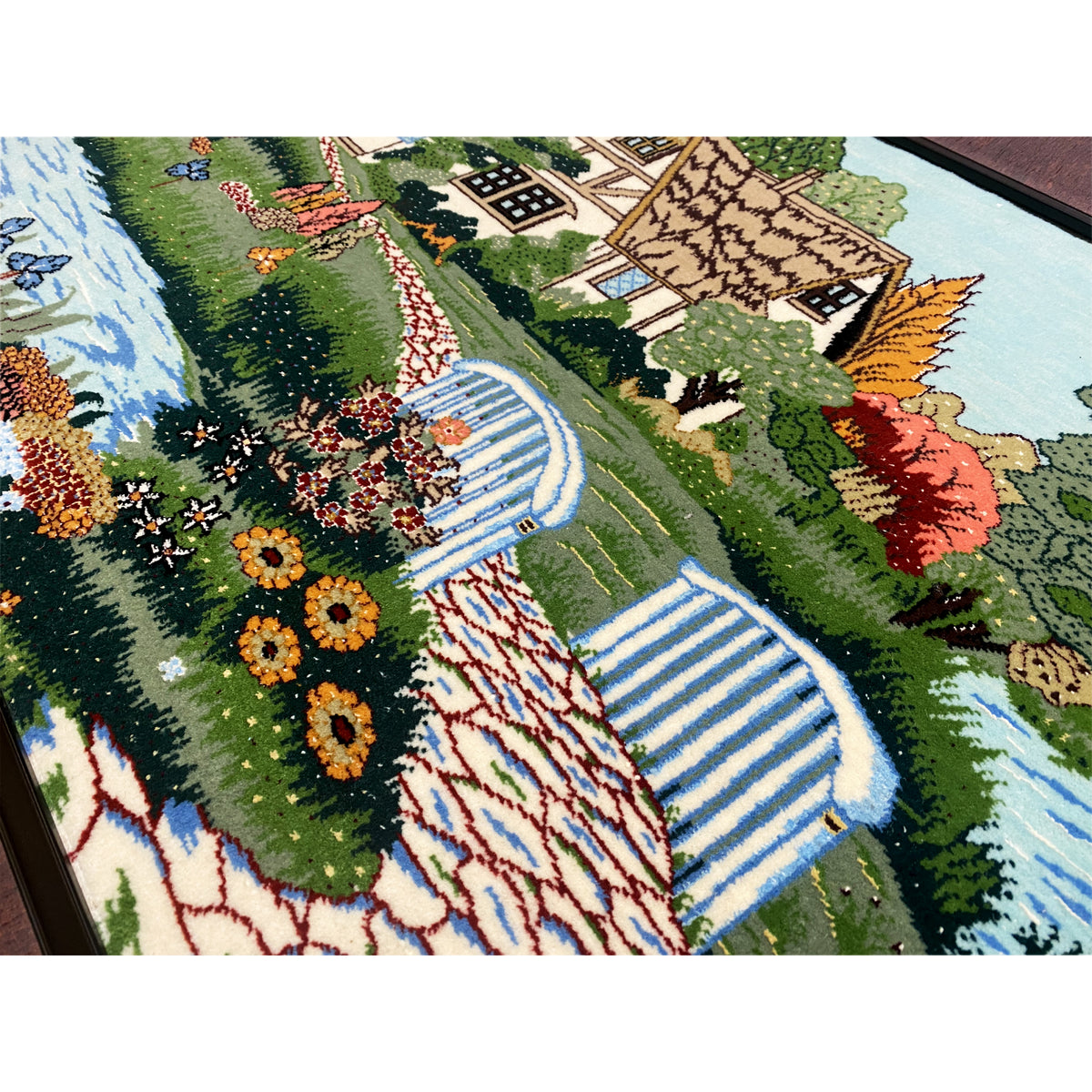 Tapestry detail view with flower beds, stream, and paved path