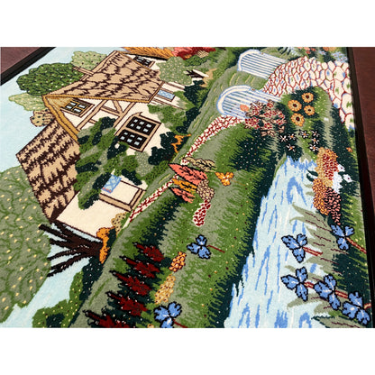 Tapestry detail view with half-timbered house, flowers, and stream with footbridge