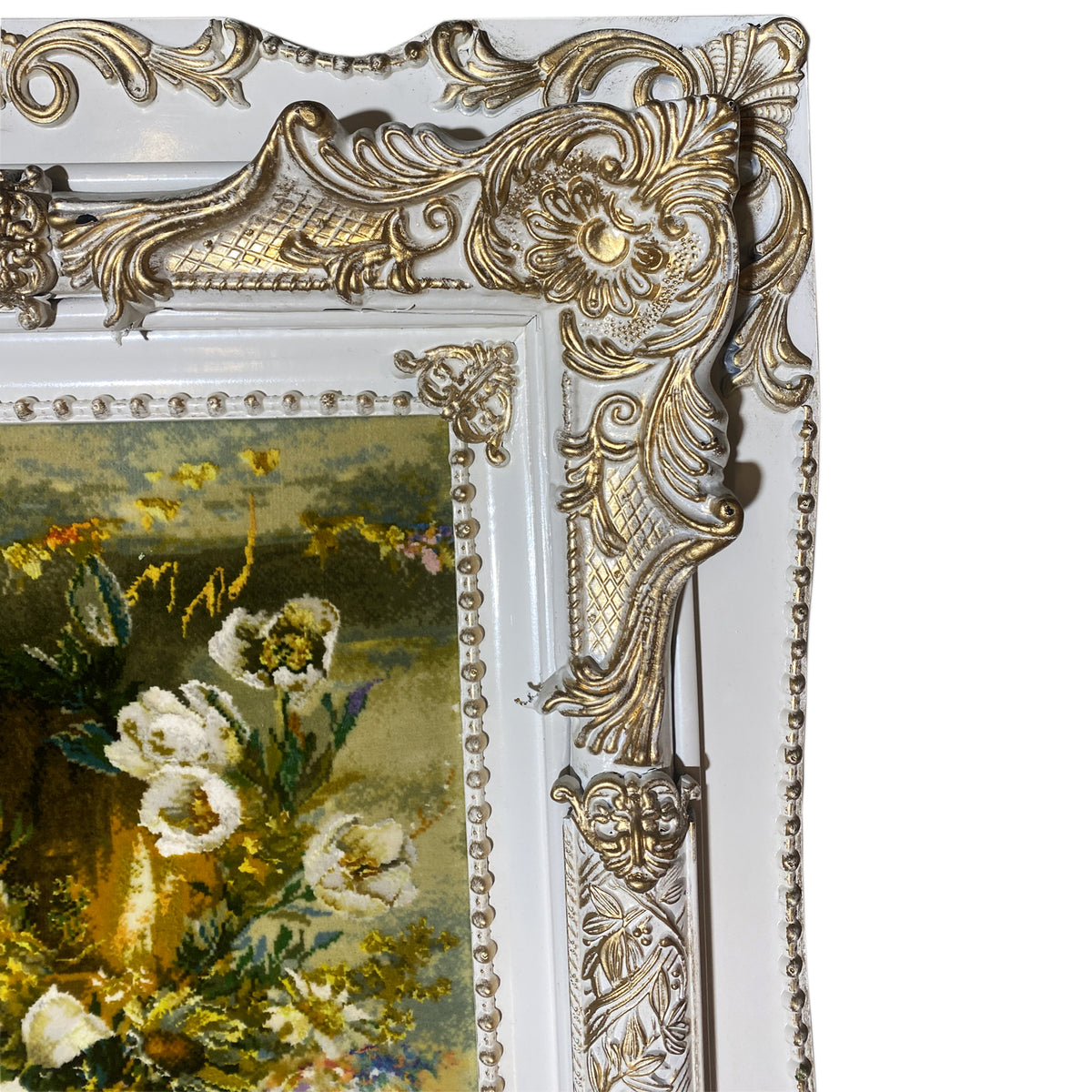Tapestry with a floral motif, an ornate frame corner, and pearl embellishments, detail view.