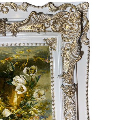 Tapestry with a floral motif, an ornate frame corner, and pearl embellishments, detail view.