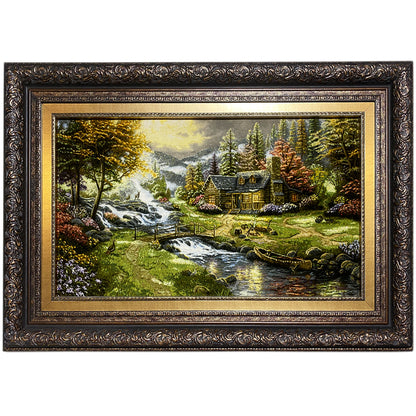 Framed landscape painting with a waterway and house, gold-colored ornamental frame design