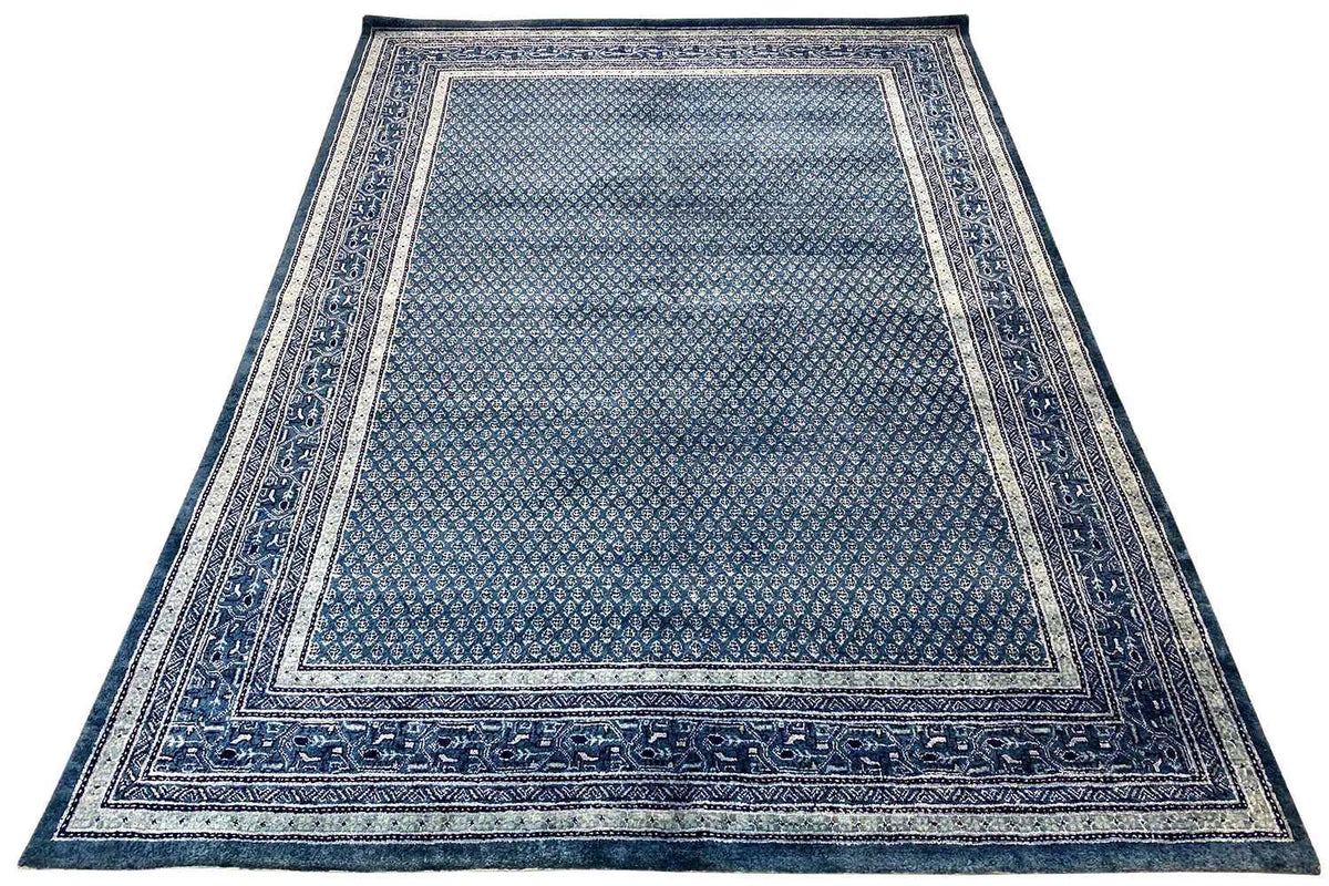Rectangular blue rug with a border and centered pattern, flat-woven