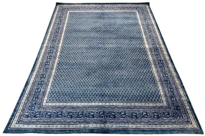 Rectangular blue rug with a border and centered pattern, flat-woven