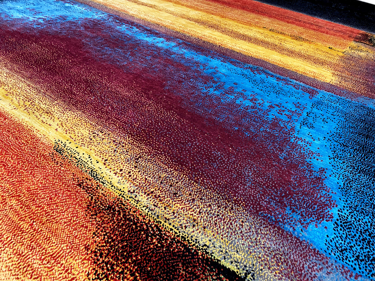 Designer rug with a colorful abstract woven pattern in blue, orange, and red
