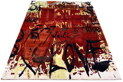 Rectangular rug with a graffiti look in reddish brown and dark blue with light speckles