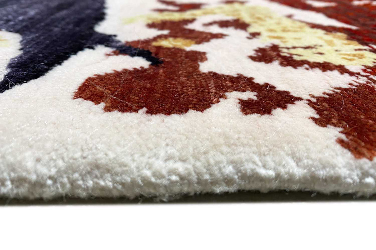 High-pile rug edge, cream-colored surface with brown patterned areas