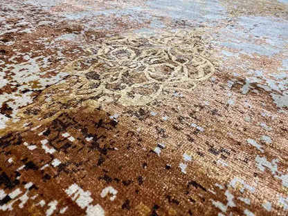 Close-up of a designer rug: brown-gold ornaments on a beige background, speckled look