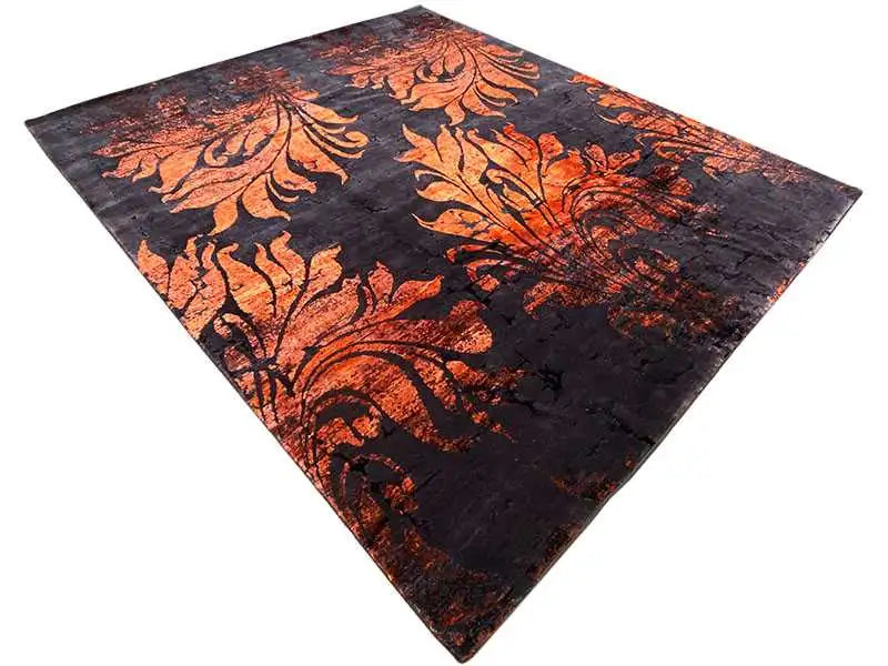 Rug in a dark design with orange ornaments, square shape viewed from above.