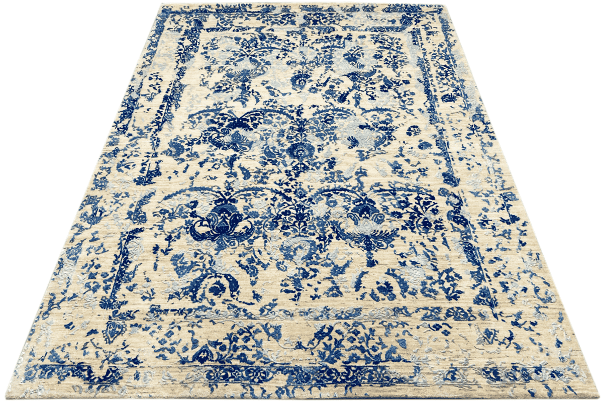 Rectangular rug: white-beige base with a bold blue ornamental and floral pattern