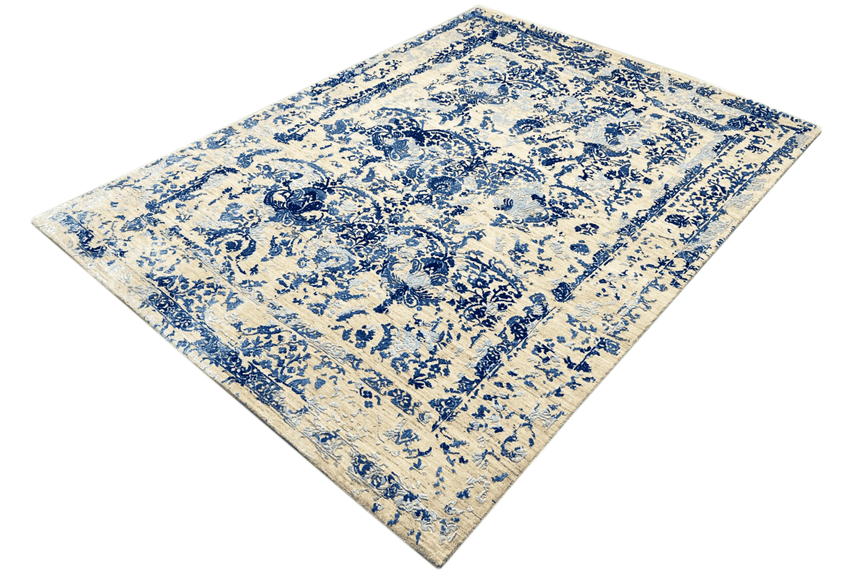 Rug positioned diagonally: blue vine and floral pattern on a beige background