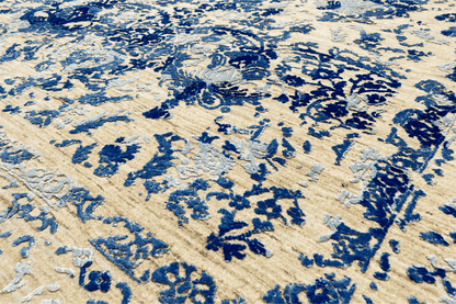 Carpet detail: blue floral ornament on a beige pile, visible texture
