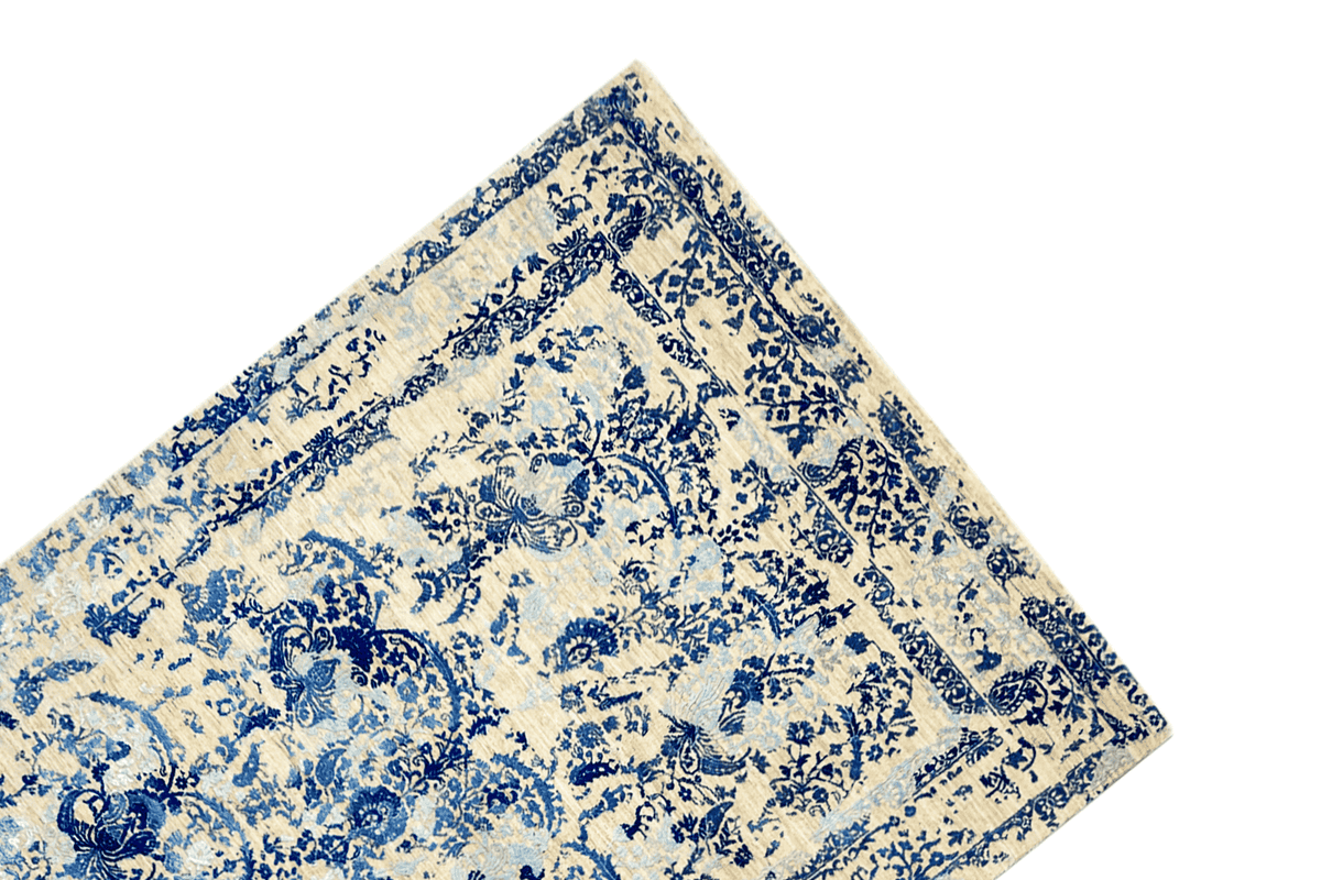 Carpet corner with a blue decorative border and floral ornamental pattern on a beige background