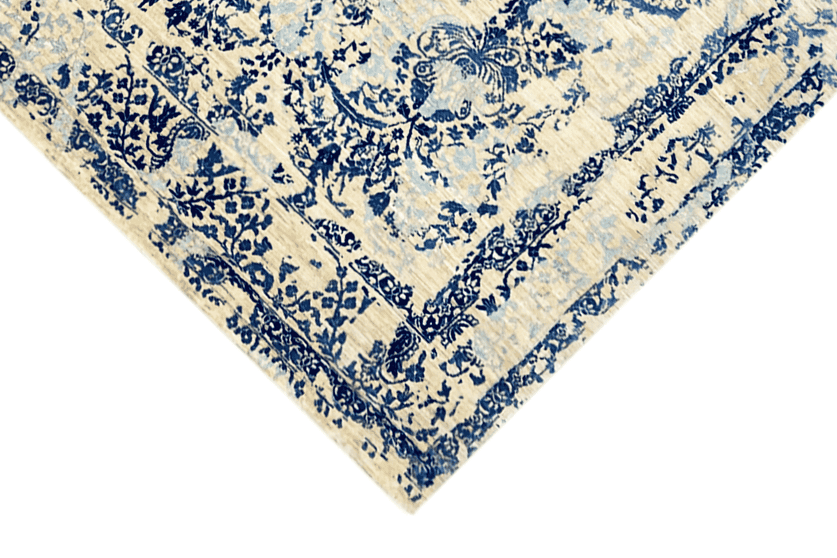 Carpet corner in detail: dense blue floral ornament on a beige background, border