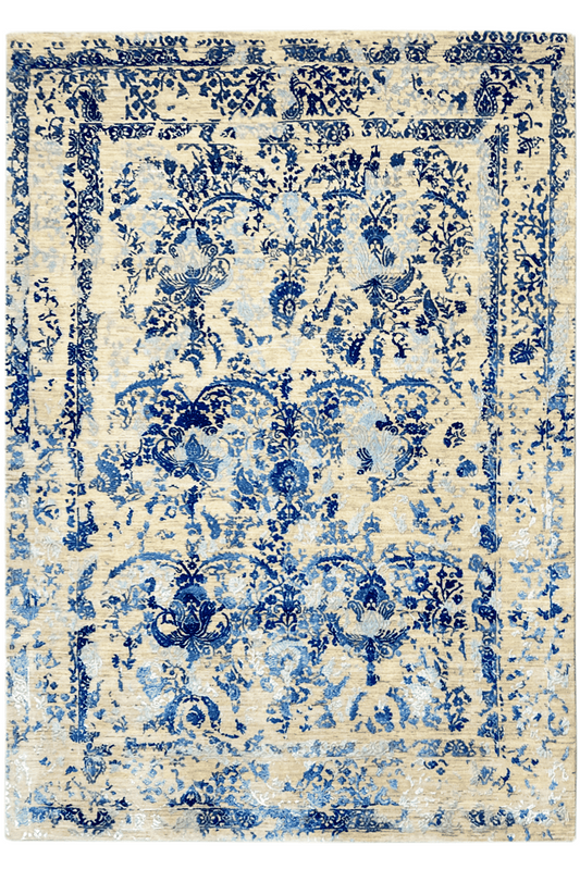 Rectangular rug with a blue floral pattern on a light background, with a decorative border