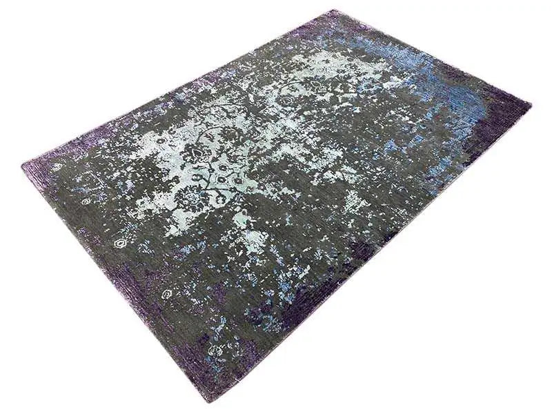 Rug 185×122 cm with geometric-looking patterns in purple-blue colors.