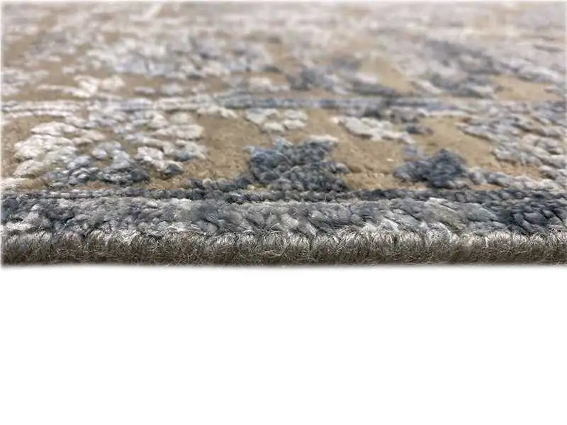 Designer rug with a short pile and raised blue-gray textured pattern