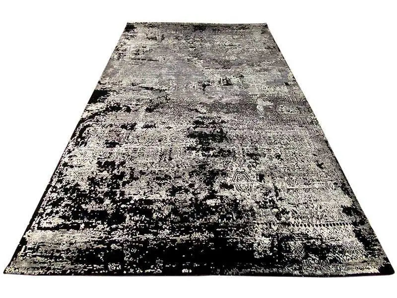 Rectangular rug with an abstract black-white-gray design on a light background