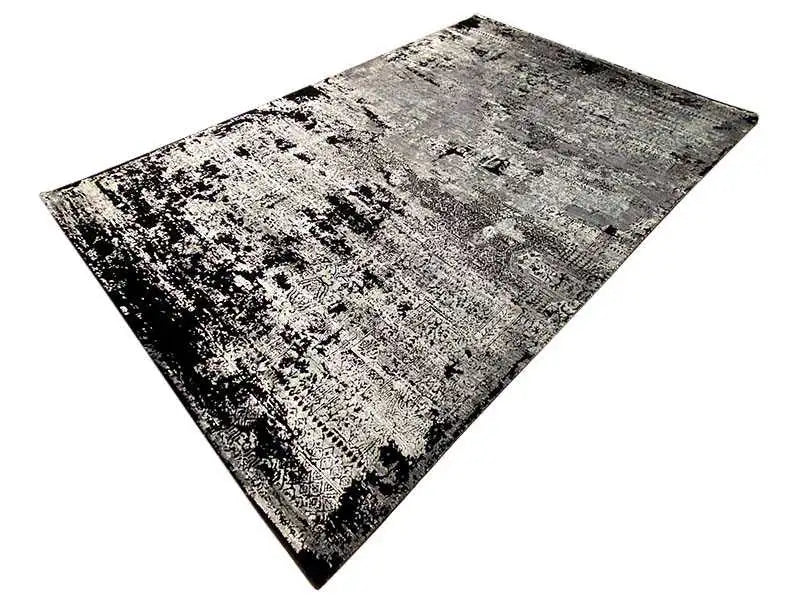 Rug at an angle: abstract gray-black with light spots