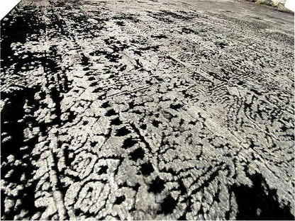 Large-area carpet surface: abstract black-and-white-gray pattern with a swirling effect