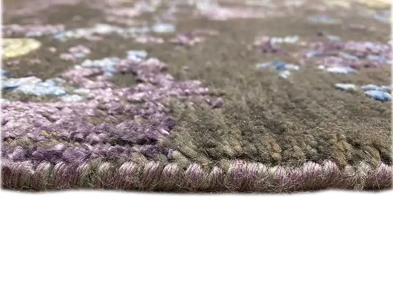 Designer rug pile detail: dense violet-brown with blue accents along the edge