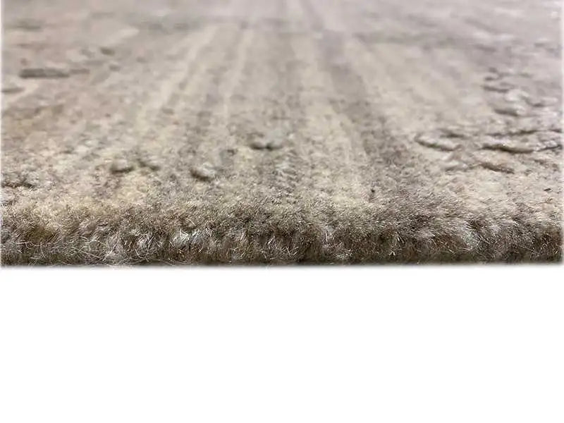Carpet detail with a mottled pile surface in gray and light accents
