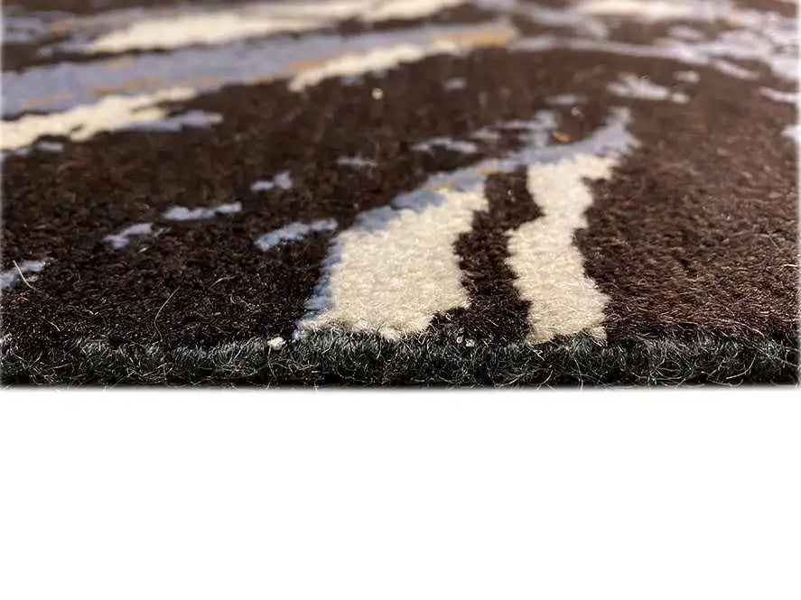 Designer rug detail: dark pile with white and light blue color blocks