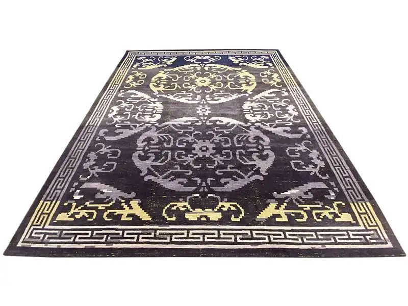 Rug with dark anthracite, white and gold-colored ornaments and a decorative border.