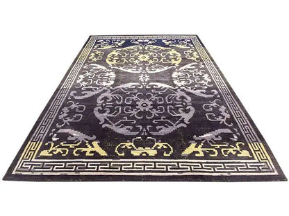 Rug with dark anthracite, white and gold-colored ornaments and a decorative border.