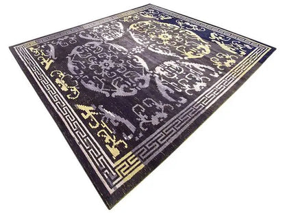 Rug: dark gray-blue field with white ornaments and gold accents, at an angle.