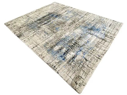 Rug in diamond view with a beige background, abstract grid pattern, and blue accents