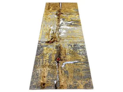Long-format rug with golden and blue-gray vintage wear patterns
