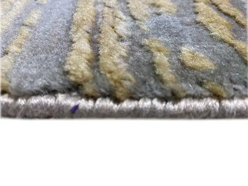 Carpet detail with short pile and a fringe border in gray-blue and beige