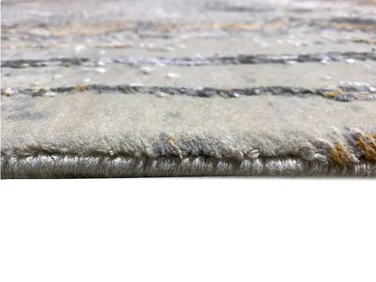 Designer rug: close-up of the rug edge with a short, dense pile in light gray