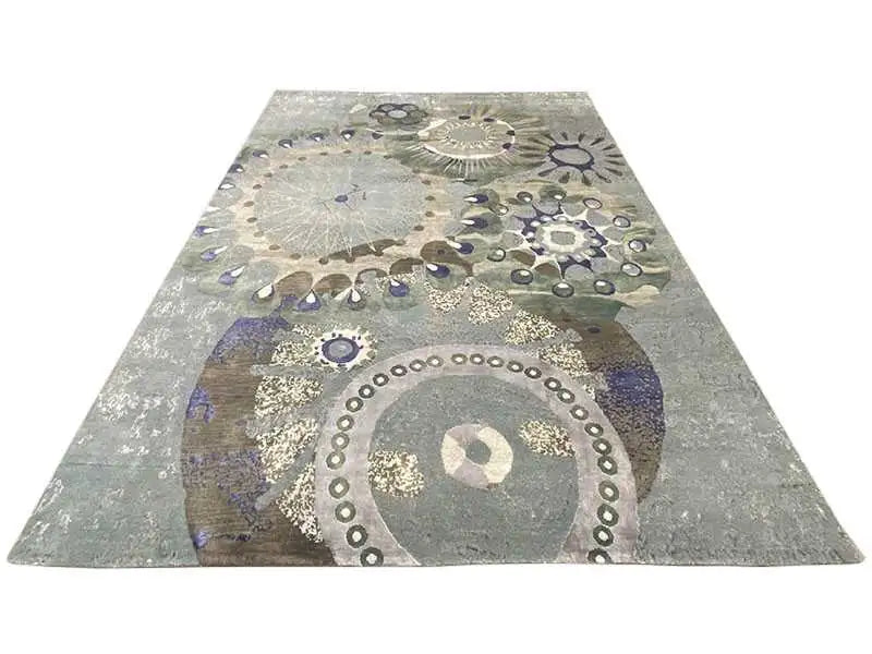 Rectangular rug with round ornaments in gray, beige, blue, and a gold look