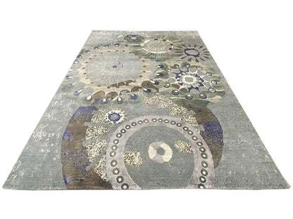 Rectangular rug with round ornaments in gray, beige, blue, and a gold look
