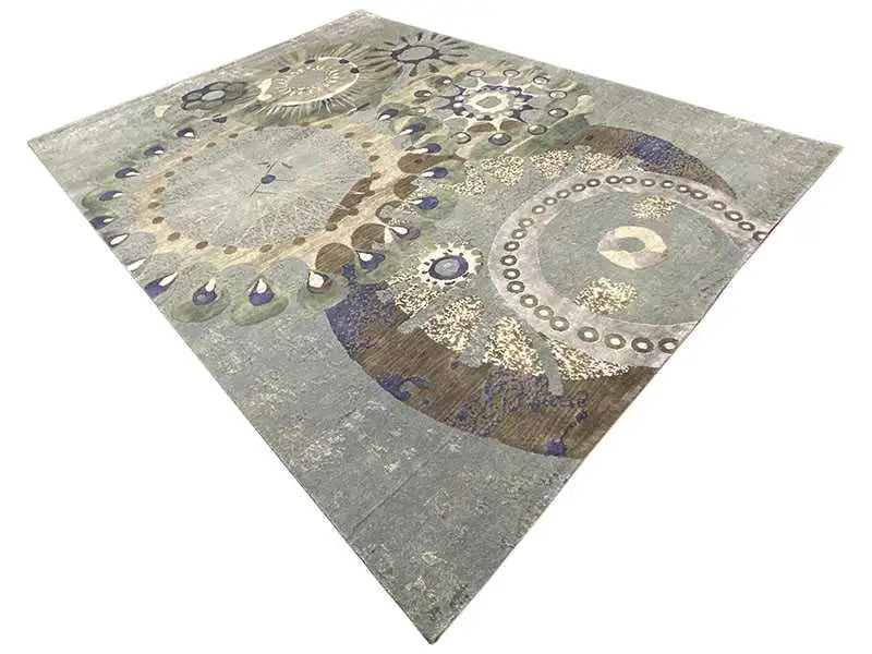 Square rug with circular and floral patterns in gray, blue, and gold