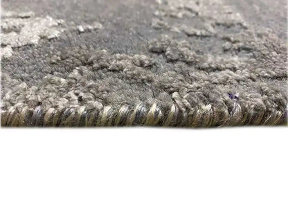 Gray marled carpet pile in detail with a subtle sheen and bound edge