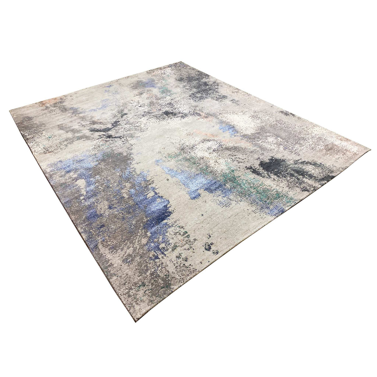 Abstract designer rug in a diagonal view: beige/gray with blue and turquoise