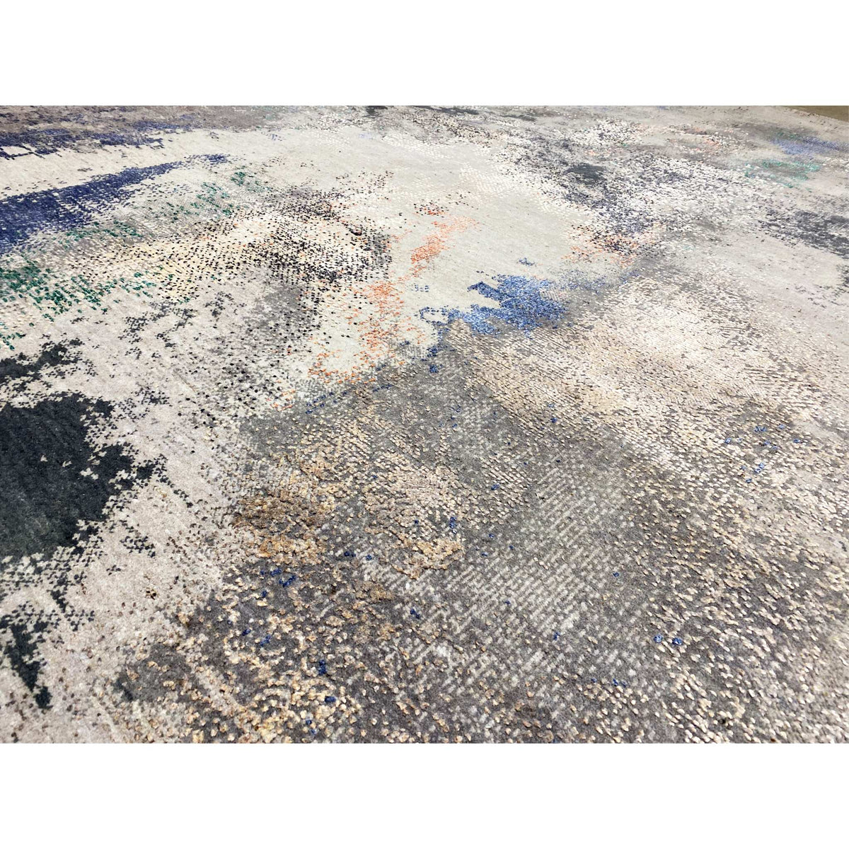 Abstract designer rug detail view: finely woven relief, beige/gray with blue