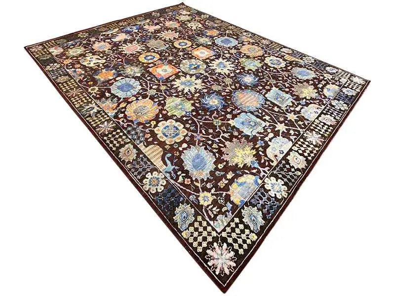 Rectangular rug with a dark background, gold and white ornaments, and a blue accent