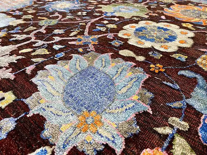 Carpet surface in detail: large light-blue flower on a dark-brown background