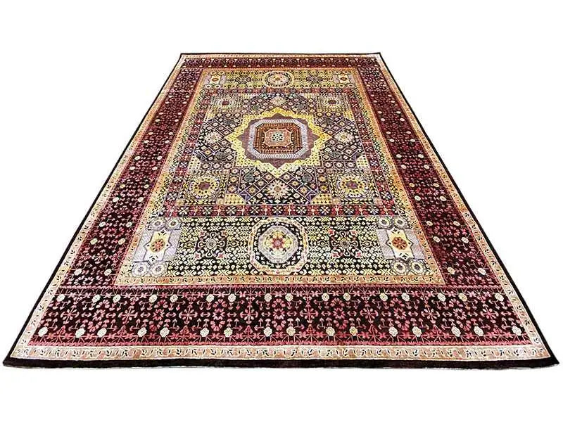 Rug with a rectangular surface and ornaments in burgundy, cream, black, and gold