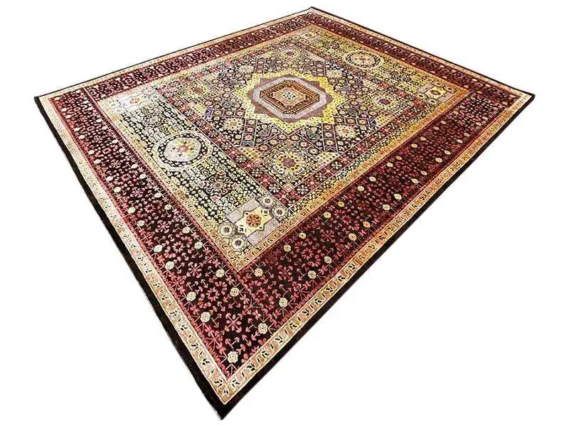 Rug with a geometric pattern and medallion in dark red, cream, and golden yellow