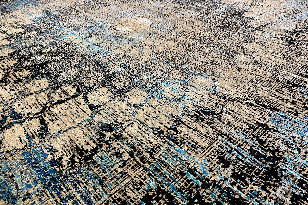 Close-up of designer rug: dense pile with abstract lines in blue and beige