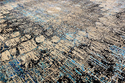Close-up of designer rug: dense pile with abstract lines in blue and beige